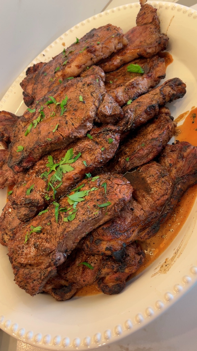 Circle 7 Black Angus NY Strip — fresh off the grill, plated with herbs